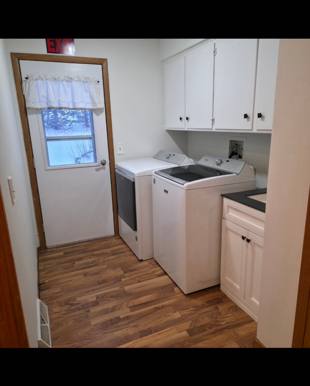 Modern laundry room with washer and dryer at Floxy AbilityNest